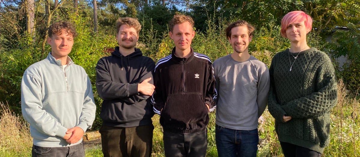 Christopher, Hayleigh, John, Moritz, and Peter standing in front of trees